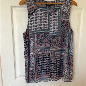 Red and Blue Sleeveless Blouse with Intricate Patterns